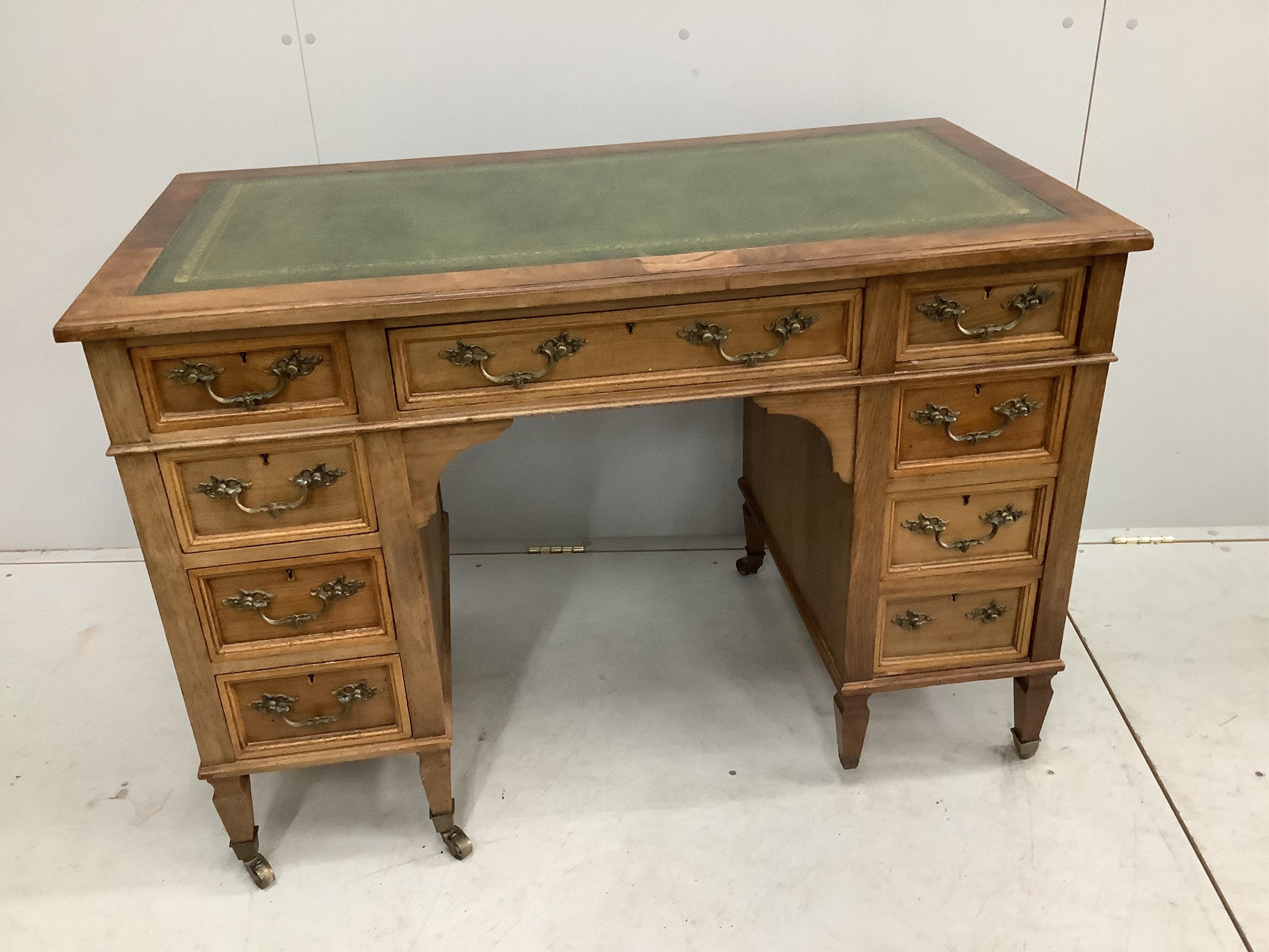 A late Victorian walnut nine drawer kneehole desk, missing two castors and one handle, width 112cm, depth 59cm, height 78cm. Condition - fair